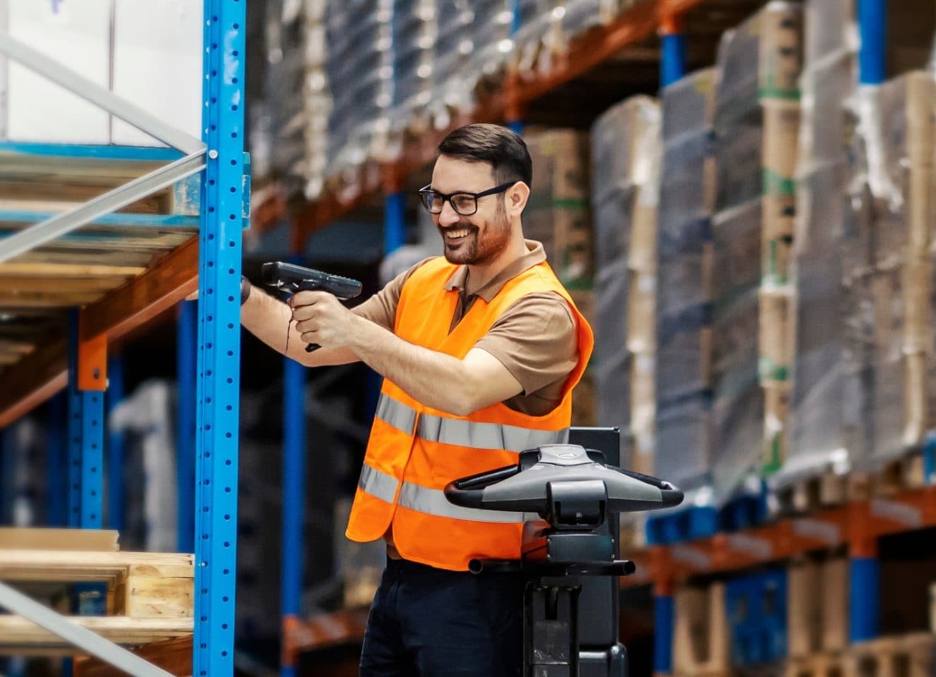 A warehouse operative scanning a pallet rack with a handheld barcode reader